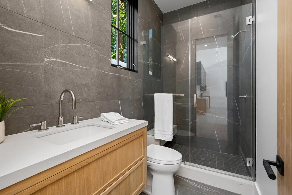 A modern small bathroom with a walk-in shower.